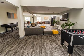 a living room with a foosball table and a game controller